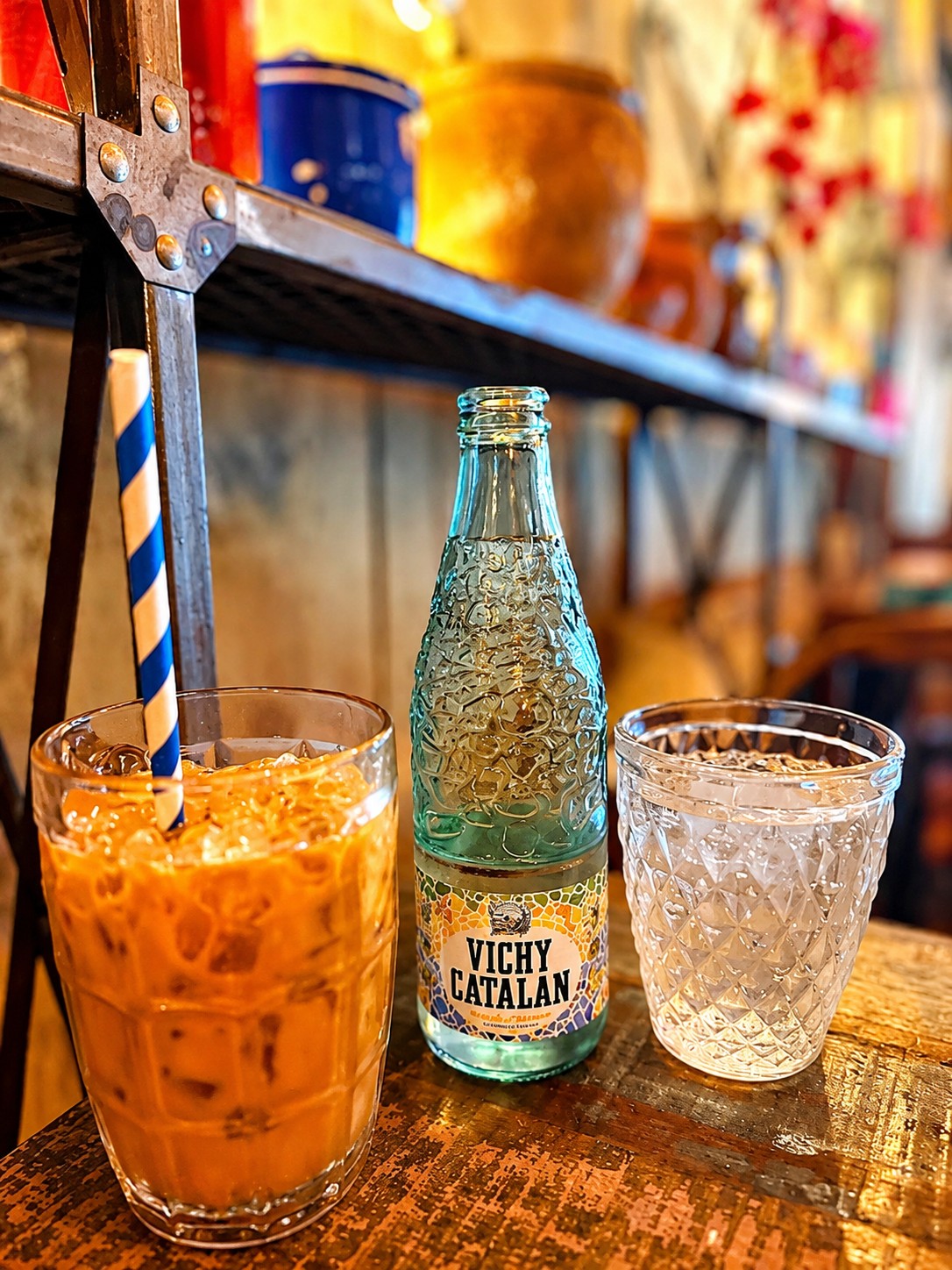 Iced Thai drink with a Vichy bottle and water glass at THAI ISAAN